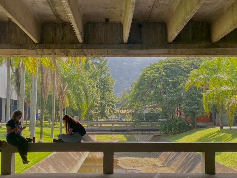 a woman sitting on a bridge